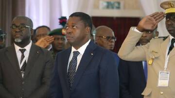Togo's legislative elections could extend President Faure Gnassingbe's (centre) 19-year-old rule. (AP PHOTO)